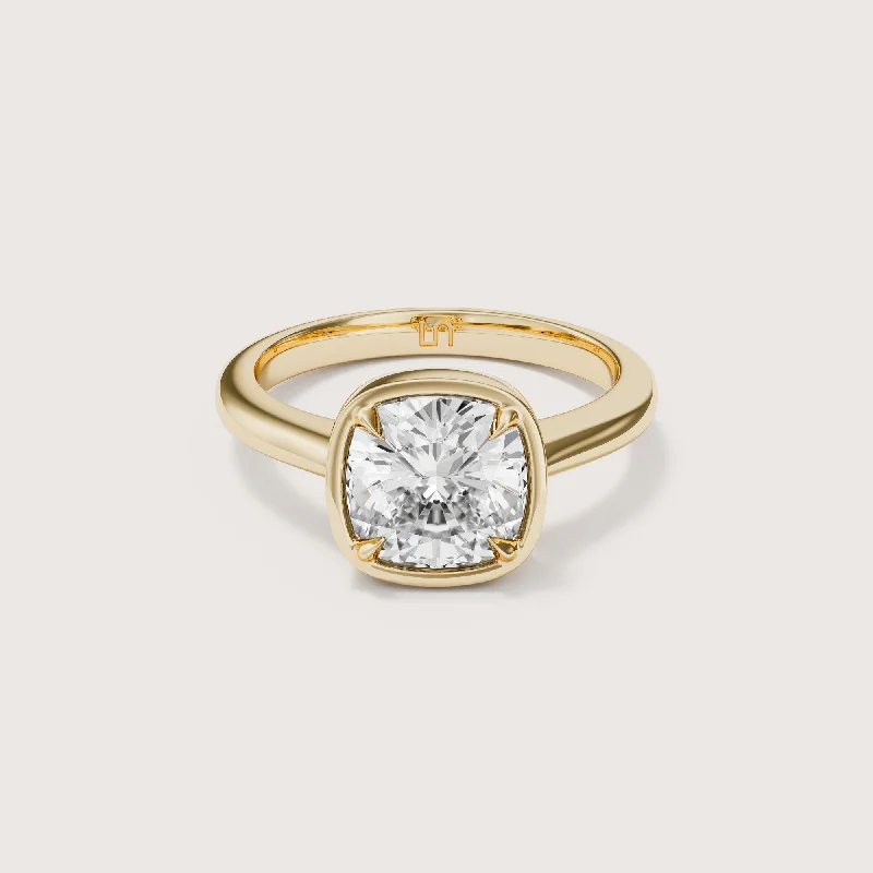 Radiant - cut diamond engagement ring with a bezel - set center stone in 18K yellow goldEdie Cushion Bezel Solitaire