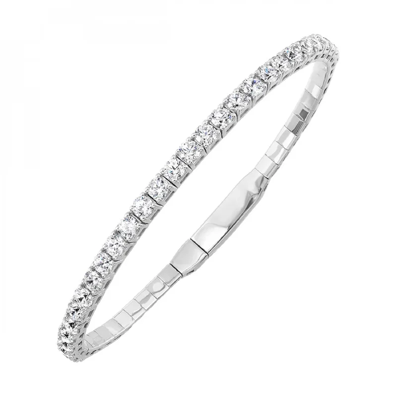 Oval - cut sapphire and diamond engagement ring in 18K white goldFlexible Diamond Bangle Bracelet, 2.0cttw