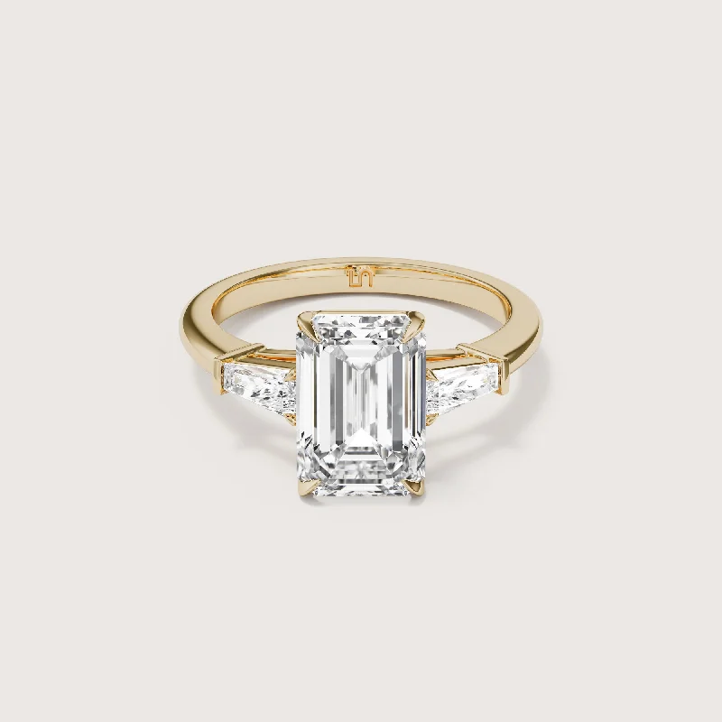 Three - stone diamond engagement ring in rose gold, symbolizing past, present, and futureMayfair Emerald Baguette Trilogy