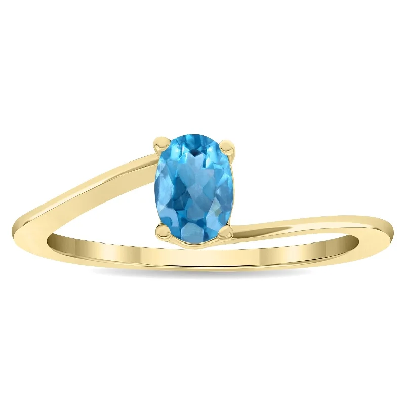 Aquamarine Gemstone Rings in 9K Gold with a Bezel Setting for a Modern and Secure FitWomen's Solitaire Oval Shaped Blue Topaz Wave Ring in 10K Yellow Gold